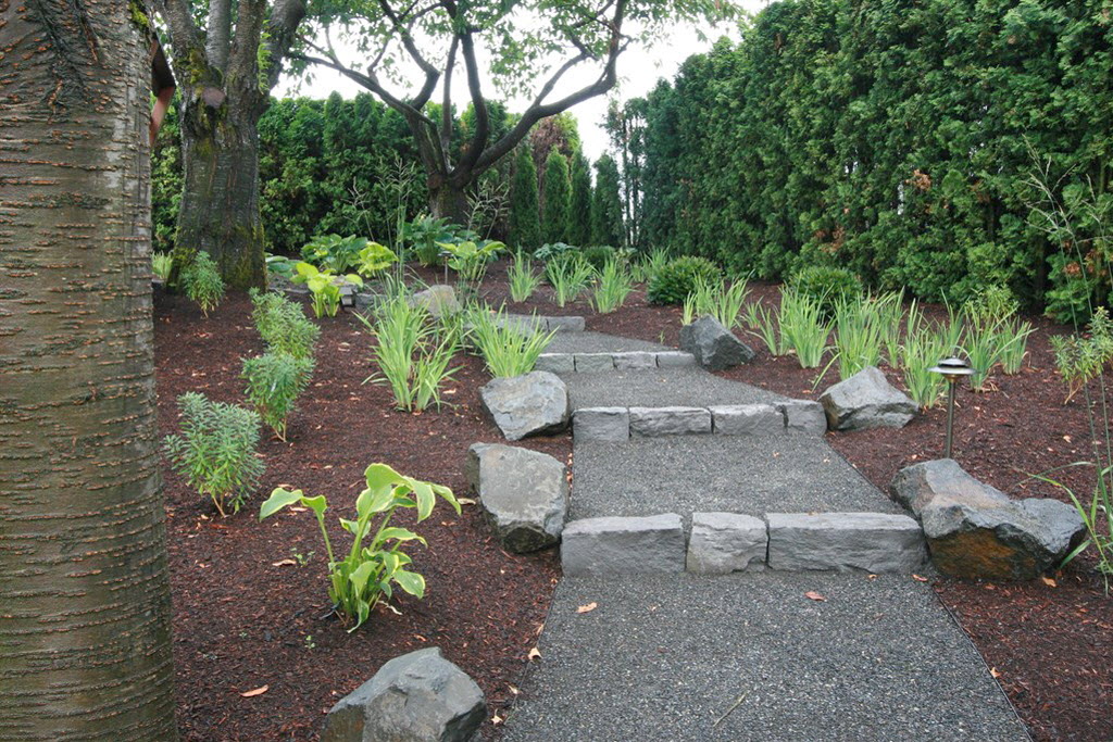 Backyard landscaping with basalt stone path.